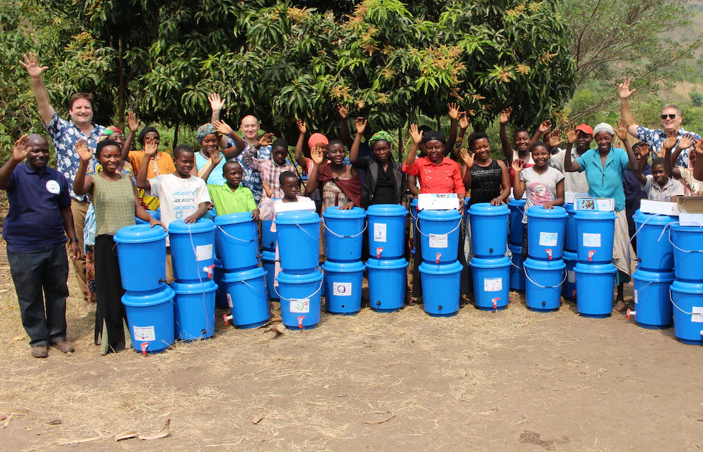 people waving with blue buckets in front of them
