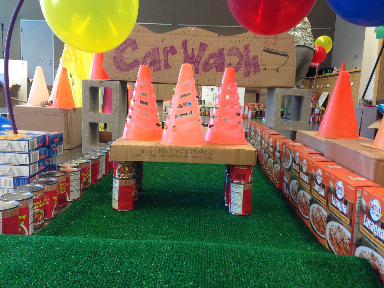 a sign that says car wash, lasagna, cans, and cones